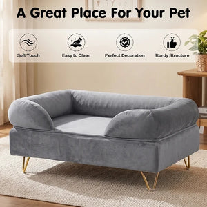 A gray velvet pet bed with gold metal legs, shown in a styled room setting with a beige rug and wooden side table. The image includes a text banner at the top reading 'A Great Place For Your Pet' and four feature icons for 'Soft Touch', 'Easy to Clean', 'Perfect Decoration', and 'Sturdy Structure' at Pet Servo