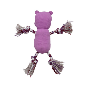 A pink textured plush dog toy shaped like a bear, with rope-tied limbs in white, burgundy, and gray, shown against a plain white background.