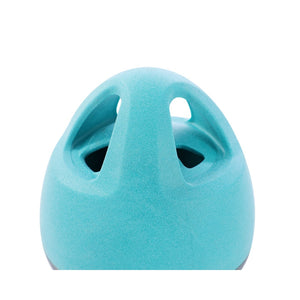 Turquoise ceramic vase with two circular holes on a white background at Pet Servo