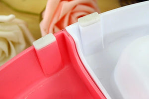 Close-up of a red and white plastic container with a blurred background at Pet Servo