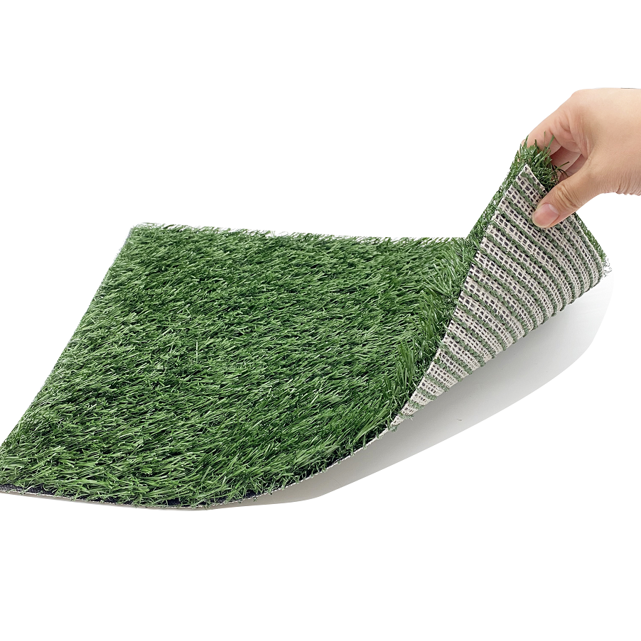 Green artificial grass mat with a textured border being held by a hand on a white background at Pet Servo