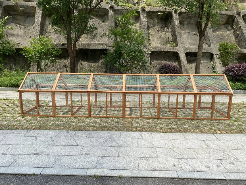 Wooden frame with glass panels in front of a concrete wall and trees at Pet Servo