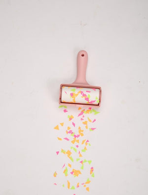 Pink roller with colorful confetti on a light gray background at Pet Servo