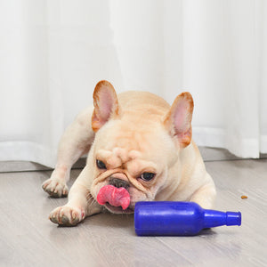 Dog playing with a blue toy on a wooden floor at Pet Servo