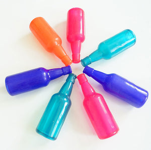 Colorful spray bottles arranged in a circle on a white background at Pet Servo