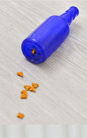 Blue bottle with a small opening on a light gray surface with orange dog treats nearby at Pet Servo