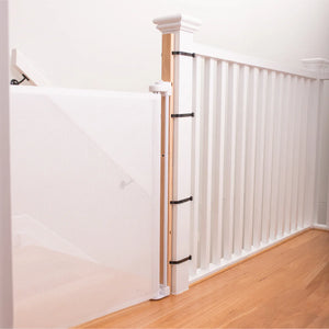 Wooden staircase with white balusters and wooden handrail in a home interior.