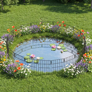 Small pond with decorative metal fence surrounded by flowers in a garden at Pet Servo