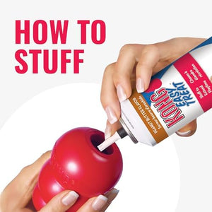 Person stuffing a red KONG toy with K9 Flyer dog food using a can at Pet Servo