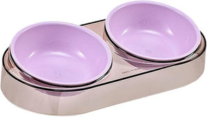 A dual pet bowl set featuring two light purple/lavender bowls nested inside a metallic rose gold base, shown on a plain white background at Pet Servo
