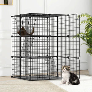 Black metal pet cage with a cat inside in a home setting