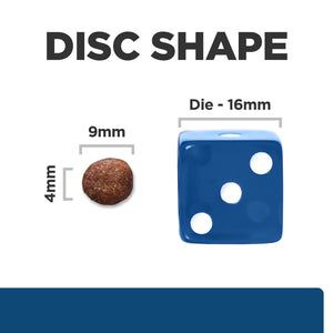 Comparison of disc shape with a die and a small round object on a white background
