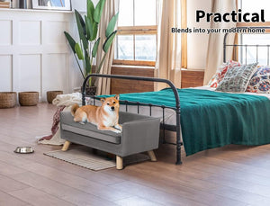 Dog lying on a small gray pet bed attached to a larger bed in a modern bedroom at Pet Servo