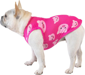 Dog wearing a pink outfit with pig designs on a white background at Pet Servo