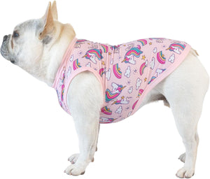 A white French Bulldog wearing a pink pet harness with a colorful unicorn and rainbow pattern, shown against a plain white background at Pet Servo