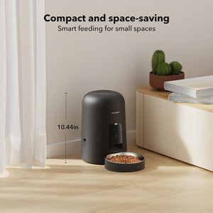 Compact pet feeder on a wooden floor with text highlighting its space-saving design.