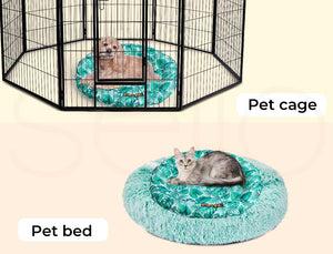A pet enclosure set showing a black metal pet cage with a dog lying on a round teal patterned cushion inside, and a gray cat lying on a fluffy round teal patterned pet bed below. Text labels read 'Pet cage' and 'Pet bed' at Pet Servo