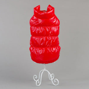 Red puffer vest on a white stand against a gray background at Pet Servo