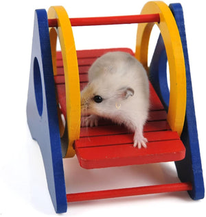 Hamster on a colorful wooden swing toy against a white background at Pet Servo