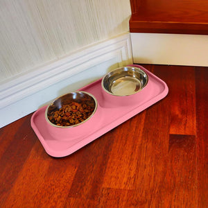 Pink pet feeding station with two metal bowls on a wooden floor at Pet Servo