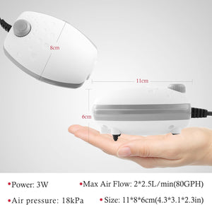 Small white air pump held in a hand with dimensions and specifications displayed at Pet Servo