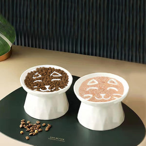 Two white pet bowls with food on a dark surface, featuring 'LIVE BETTER SIMPLE KITCHEN' branding at Pet Servo