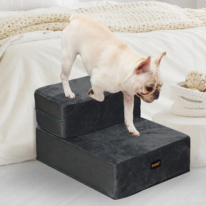 Dog using a set of black pet steps on a bed at Pet Servo