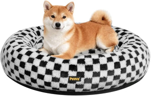 Dog lying on a checkered pet bed with 'Pawz' branding at Pet Servo