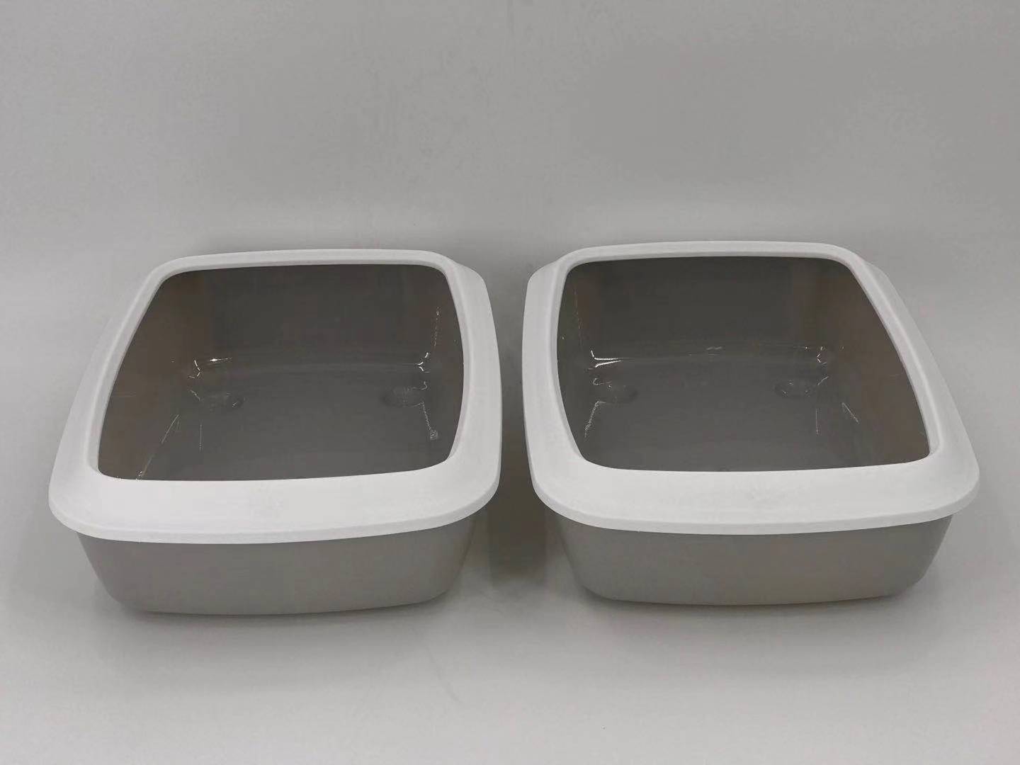 Two gray pet litter boxes with white lids on a gray background at Pet Servo