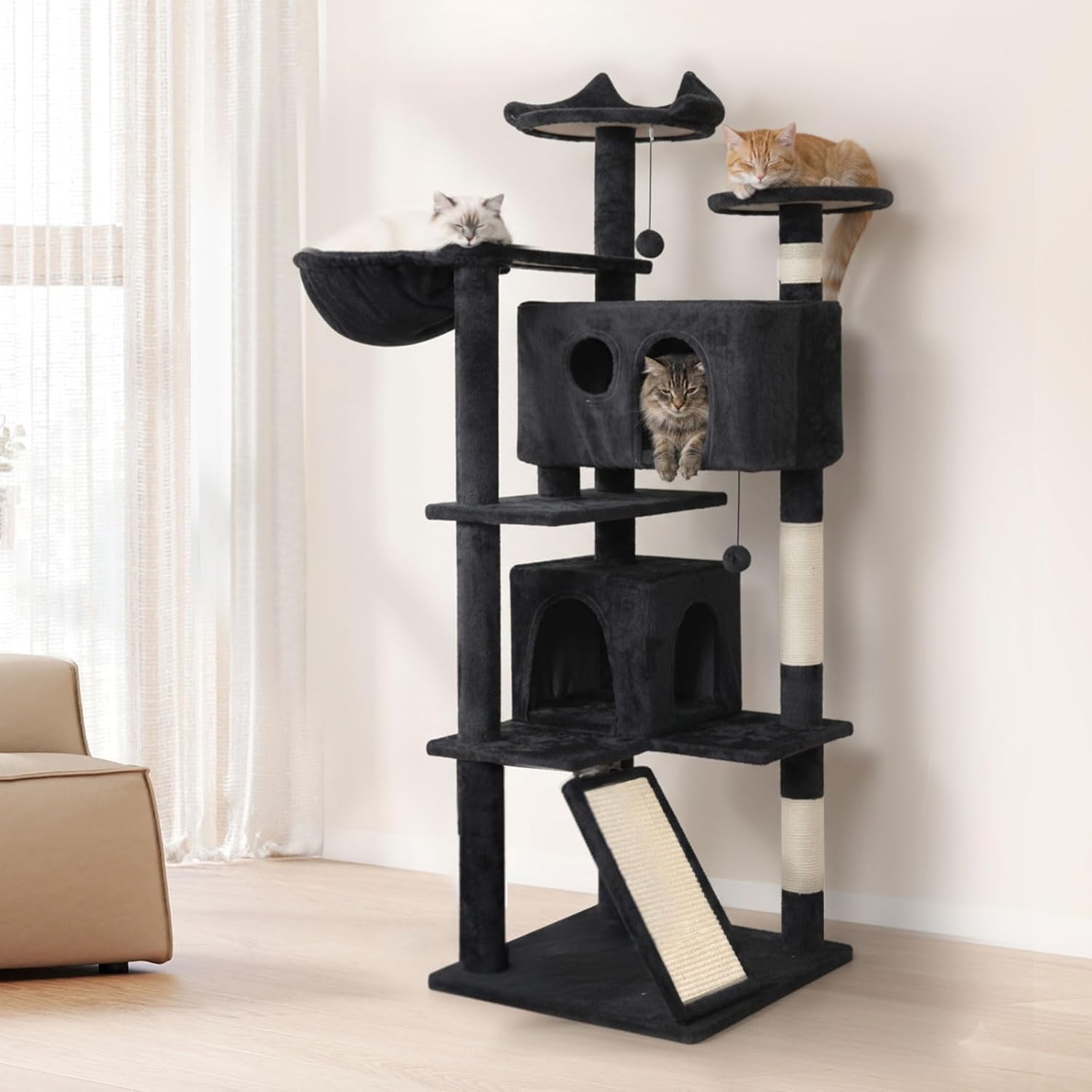 A tall black cat tree with multiple levels, platforms, a hanging bed, an enclosed cave, a scratching post, and two cats resting on it in a bright room at Pet Servo