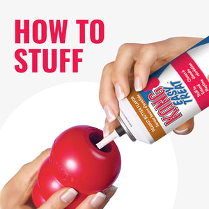 Person stuffing a red KONG toy with K9 Flyer dog food using a can at Pet Servo