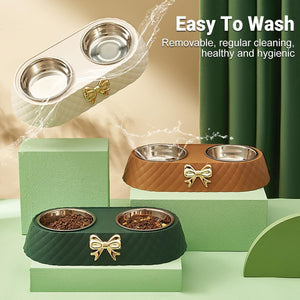 Pet bowls with a decorative bow, placed on green and brown stands with water splashing around them at Pet Servo