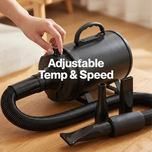 A black cylindrical portable dryer with a flexible hose and multiple attachment nozzles on a wooden floor, with a hand adjusting a dial on top. White text overlay reads 'Adjustable Temp & Speed' at Pet Servo