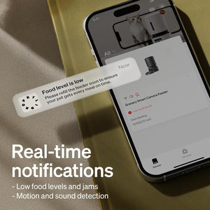 Smart camera feeder app on a smartphone with real-time notifications displayed.