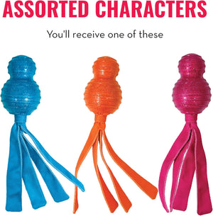 Three textured ball-shaped dog toys with long ribbon tails in blue, orange, and pink, displayed side-by-side under the text 'ASSORTED CHARACTERS' and 'You'll receive one of these' on a white background at Pet Servo