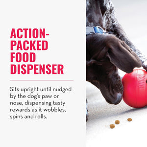Dog interacting with a red KONG food dispenser toy on a light surface at Pet Servo