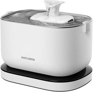 White pet water bowl with a black base and lid on a white background