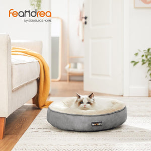 Cat lying on a Feandrea pet bed in a cozy living room at Pet Servo