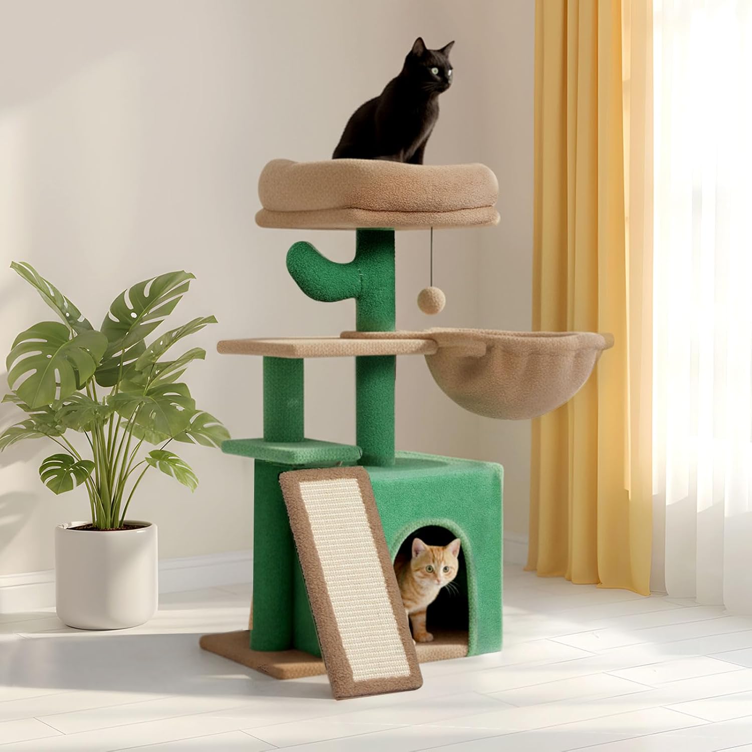 A green and beige cat tree with multiple levels, a black cat sitting on the top perch, and a light-colored cat peeking out of the bottom cave. The scene is set in a bright room with a potted plant, yellow curtains, and a white window at Pet Servo