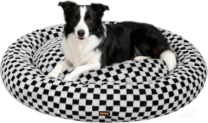 Dog lying on a black and white checkered pet bed with a visible brand logo at Pet Servo