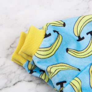Pair of socks with banana pattern on a marble surface at Pet Servo