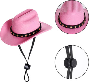 Pink cowboy-style hat with a black band decorated with gold stars, shown on a white background with two circular detail insets highlighting the band and the black chin strap closure at Pet Servo