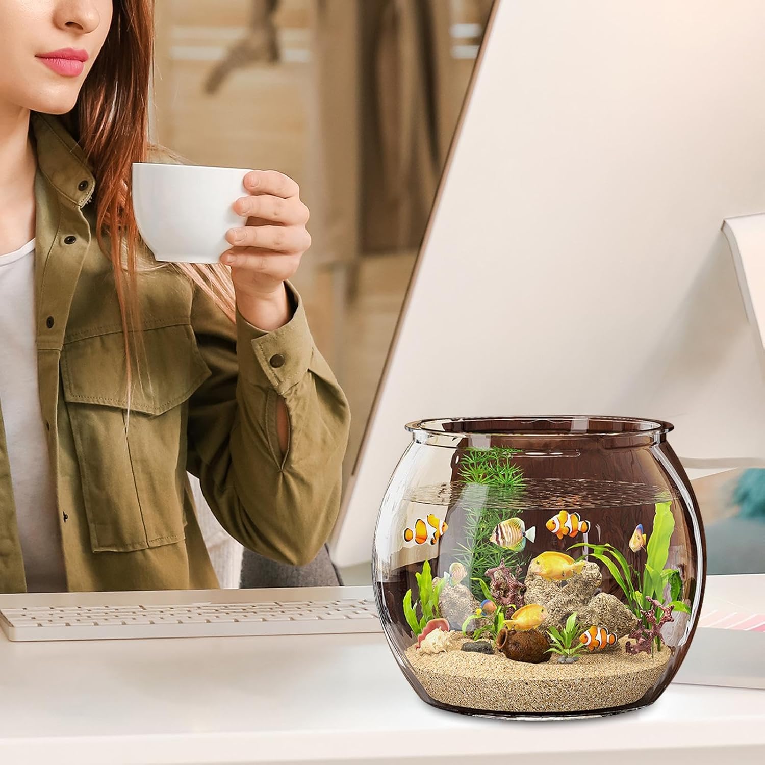 Person holding a cup with a small fish tank on a desk at Pet Servo