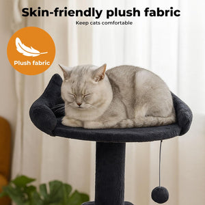 A light gray cat rests on a plush black cat tree perch with a padded cushion and a dangling ball toy. Text at the top reads 'Skin-friendly plush fabric' with a feather icon and orange circle badge at Pet Servo