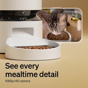 Smart pet feeder with 1080p HD camera displaying a cat eating from a bowl.