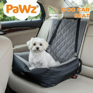 Dog sitting on a black and gray dog car seat in a car with 'PaWz' branding at Pet Servo