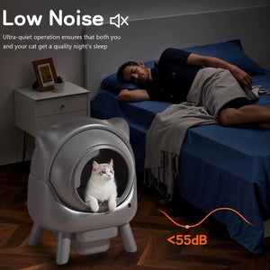 Cat using a low noise litter box in a bedroom with a man sleeping.