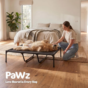 Woman petting a dog on a pet bed in a bedroom with 'PaWz' branding at Pet Servo