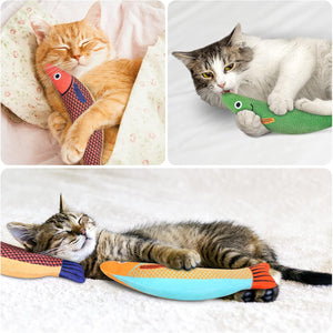 Three cats interacting with colorful fish-shaped catnip toys on a soft surface at Pet Servo