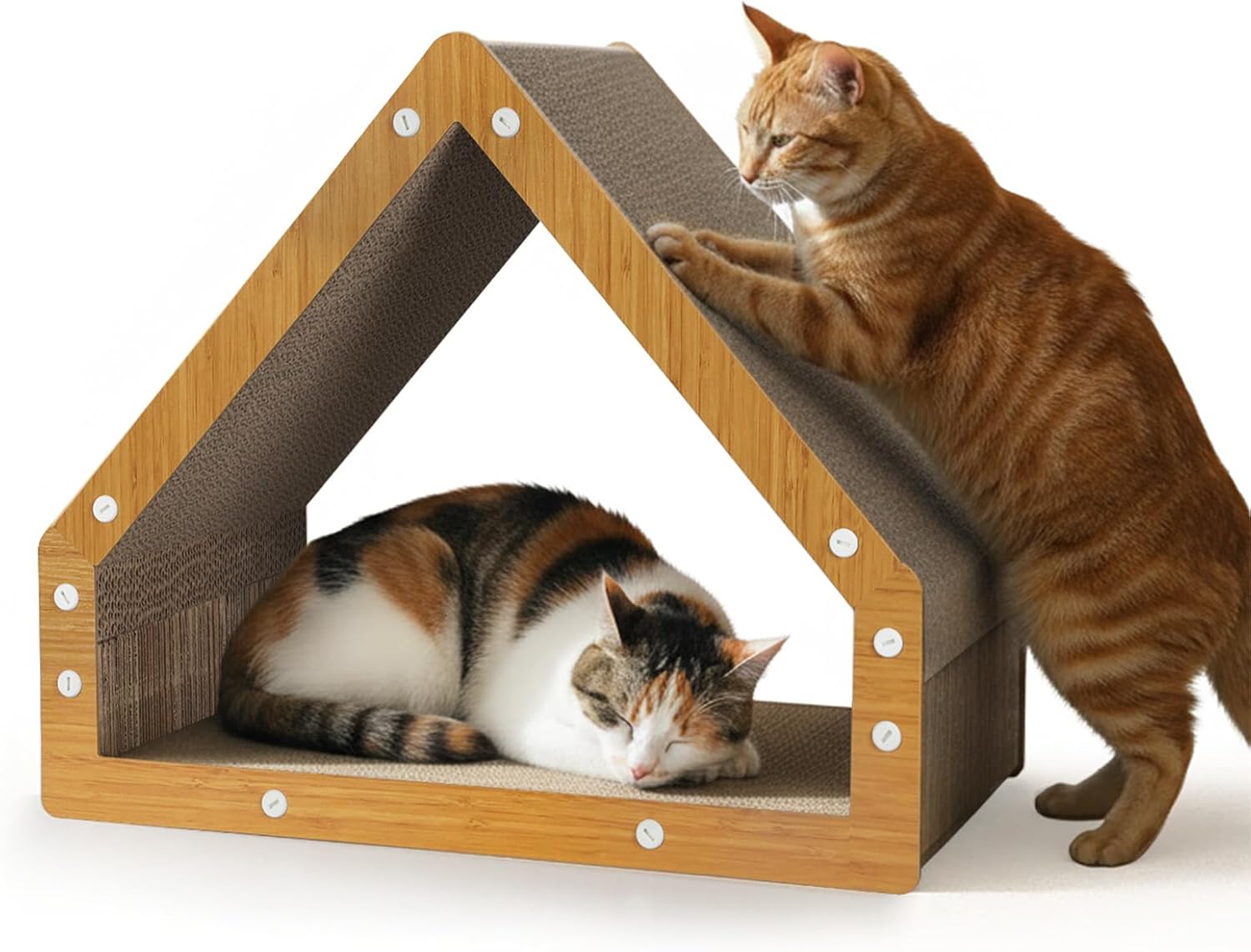 A house-shaped cat scratching and resting platform with a light wood frame and brown corrugated inner walls, shown with two cats on a white background. One orange tabby cat stands on its hind legs touching the roof, and another calico cat rests inside the platform at Pet Servo